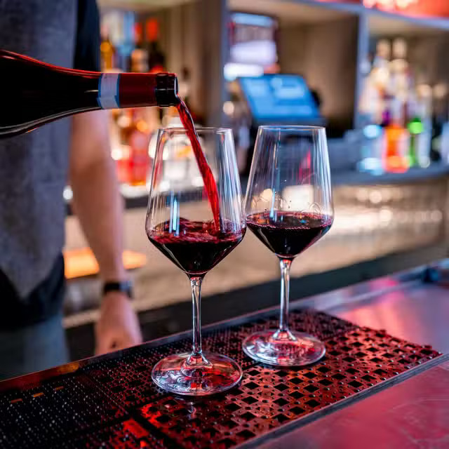 A glass of wine being poured at Poppy East Village.